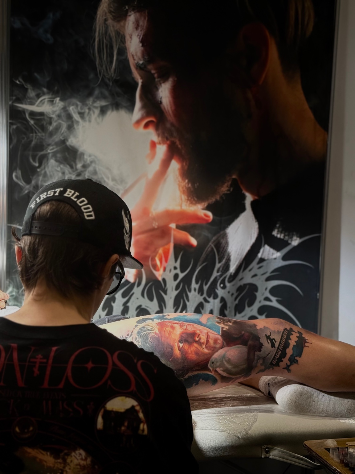 Vladimir Vishar tattooing a client's arm in the studio